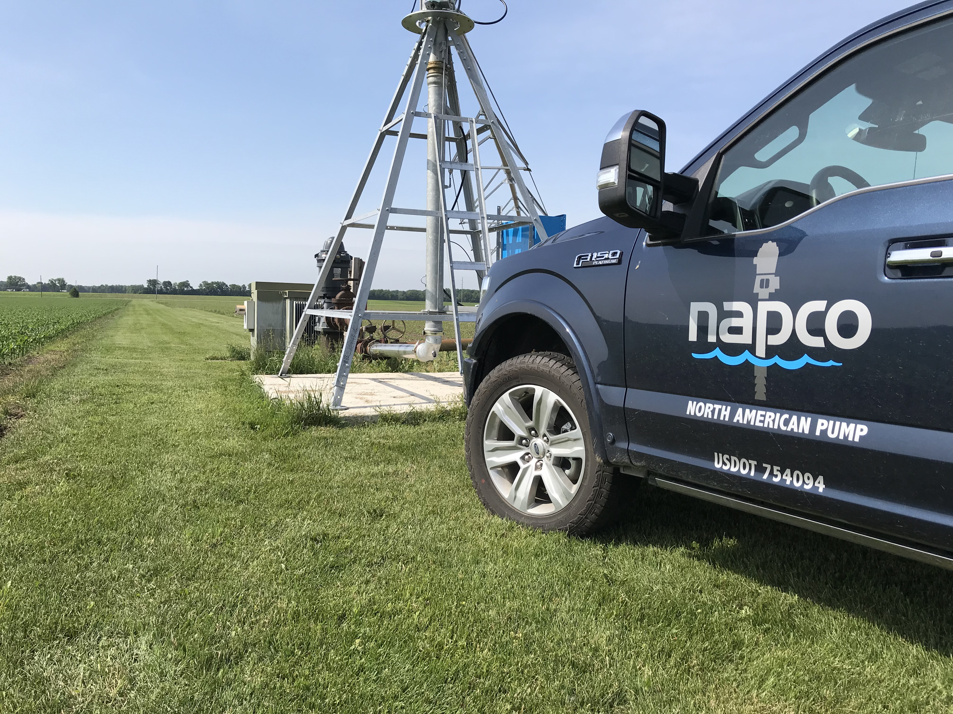 NAPCO truck parked in a farm field by a pivot